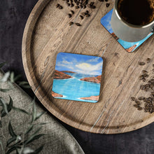 Load image into Gallery viewer, Corkwood underside, glossy finish on top. 1 or 4 pc sets. 9.5x9.5cm. Outback Australia Islands, clouds, sunrays, blue water