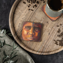 Load image into Gallery viewer, Corkwood underside, glossy finish on top. 1 or 4 pc sets. 9.5 x 9.5cm. Close up portrait of a First Nations Aboriginal