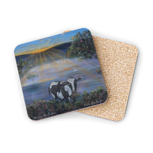 Load image into Gallery viewer, Corkwood underside, glossy finish on top. 1 or 4 pc sets. 9.5 x 9.5cm. Black & white cow eating grass at sunrise. Sunrays