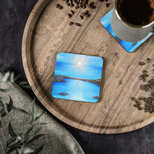 Load image into Gallery viewer, Corkwood underside, glossy finish on top. 1 or 4 pc sets. 9.5 x 9.5cm. Blue sea at sunset / sunrise