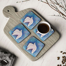 Load image into Gallery viewer, Corkwood underside, glossy finish on top. 1 or 4 pc sets. 9.5 x 9.5cm. White bird / dove flying over an abstract background