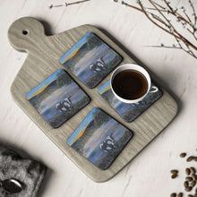 Load image into Gallery viewer, Corkwood underside, glossy finish on top. 1 or 4 pc sets. 9.5 x 9.5cm. Black & white cow eating grass at sunrise. Sunrays