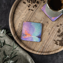 Load image into Gallery viewer, Corkwood underside, glossy finish on top. 1 or 4 pc sets. 9.5 x 9.5cm. Mystical colourful sky w/ a soul star guiding the way