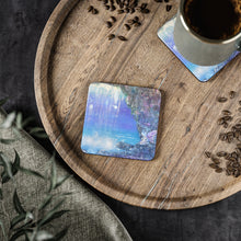 Load image into Gallery viewer, Corkwood underside, glossy finish on top. 1 or 4 pc sets. 9.5 x 9.5cm. Whimsical fairy playground behind a waterfall