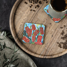 Load image into Gallery viewer, Corkwood underside, glossy finish on top. 1 or 4 pc sets. 9.5 x 9.5cm. Impressionistic painting of red bottle brush flowers