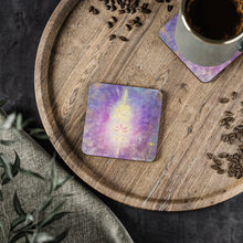 Load image into Gallery viewer, Corkwood underside, glossy finish on top. 1 or 4 pc sets. 9.5x9.5cm. Spiritual symbol of a unalome on purple background