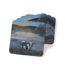 Load image into Gallery viewer, Corkwood underside, glossy finish on top. 1 or 4 pc sets. 9.5 x 9.5cm. Black & white cow eating grass at sunrise. Sunrays