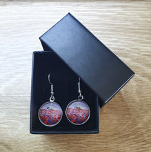 Load image into Gallery viewer, 16mm Earrings - Sunrise (ANZAC Crest), silhouette of soldier with horse drinking from a hat, a field of red &amp; purple poppies
