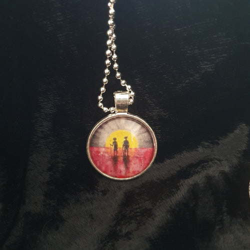 25mm Pendant/Chain -Abstract Aboriginal flag/Rising Sun silhouette of Aboriginal holding spear, soldier holding gun & poppies