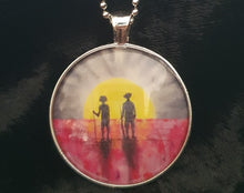 Load image into Gallery viewer, 38mm Pendant/Chain -Abstract Aboriginal flag/Rising Sun silhouette of Aboriginal holding spear, soldier holding gun & poppies