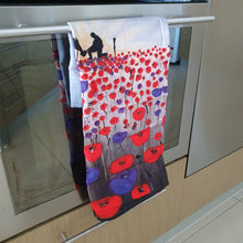 Load image into Gallery viewer, Sunrise, silhouette of soldier next to a horse drinking from his hat in a field of red & purple poppies - cotton tea towel