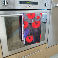 Load image into Gallery viewer,  Partial image from an original artwork of a field of red and purple poppies on a cotton tea towel
