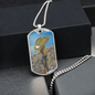 Digger's slouch hat resting on a gun with an ANZAC inspired Crest on a military style dog tag pendant with ball chain