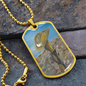 Digger's slouch hat resting on a gun with an ANZAC inspired Crest on a military style dog tag pendant with ball chain