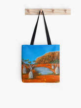 Load image into Gallery viewer, large rock formation, boab trees, a billabong and emu with beautiful orange and blue complimentary colours 40x40cm tote bag
