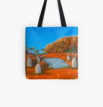 Load image into Gallery viewer, large rock formation, boab trees, a billabong and emu with beautiful orange and blue complimentary colours 40x40cm tote bag

