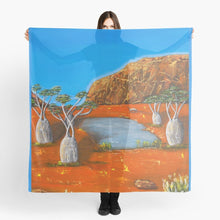 Load image into Gallery viewer, Large rock formation, boab trees, billabong & emu, Beautiful orange & blue complimentary colours 140x140cm scarf/wrap/shawl