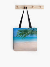 Load image into Gallery viewer, Original painting of a tranquil tropical beach with palm leaves on a 41 x 41cm tote bag