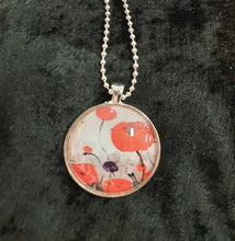 Load image into Gallery viewer, Original painting of red poppies with an abstract background on a silver coloured 30mm pendant with a 60cm ball chain