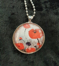 Load image into Gallery viewer, Original painting of red poppies with an abstract background on a silver coloured 38mm pendant with a 60cm ball chain