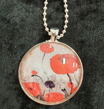 Load image into Gallery viewer, Original painting of red poppies with an abstract background on a silver coloured 30mm pendant with a 60cm ball chain