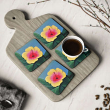 Load image into Gallery viewer, Corkwood underside, glossy finish on top. 1 or 4 pc sets. 9.5 x 9.5cm. Yellow &amp; pink hibiscus on greenery
