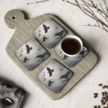Load image into Gallery viewer, Corkwood underside, glossy finish on top. Available in 1 or 4 pc sets. 9.5 x 9.5cm. Scene of crows, ravens, blackbirds flying
