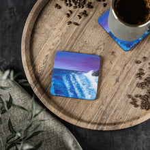 Load image into Gallery viewer, Corkwood underside, glossy finish on top. 1 or 4 pc sets. 9.5 x 9.5cm. Waves crashing on rocks with a magenta sunset
