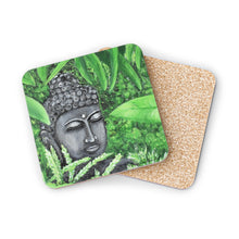 Load image into Gallery viewer, Corkwood underside, glossy finish on top. 1 or 4 pc sets. 9.5 x 9.5cm. Serene Buddha statue head amongst garden greenery
