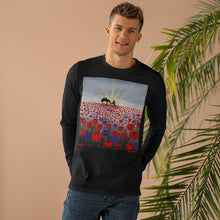 Load image into Gallery viewer, Original artwork of a sunrise (in the form of the ANZAC Crest) with a silhouette of a soldier kneeling next to his horse drinking from his hat in a field of red and purple poppies on the front of a unisex long sleeve tee. Available in black or white.
