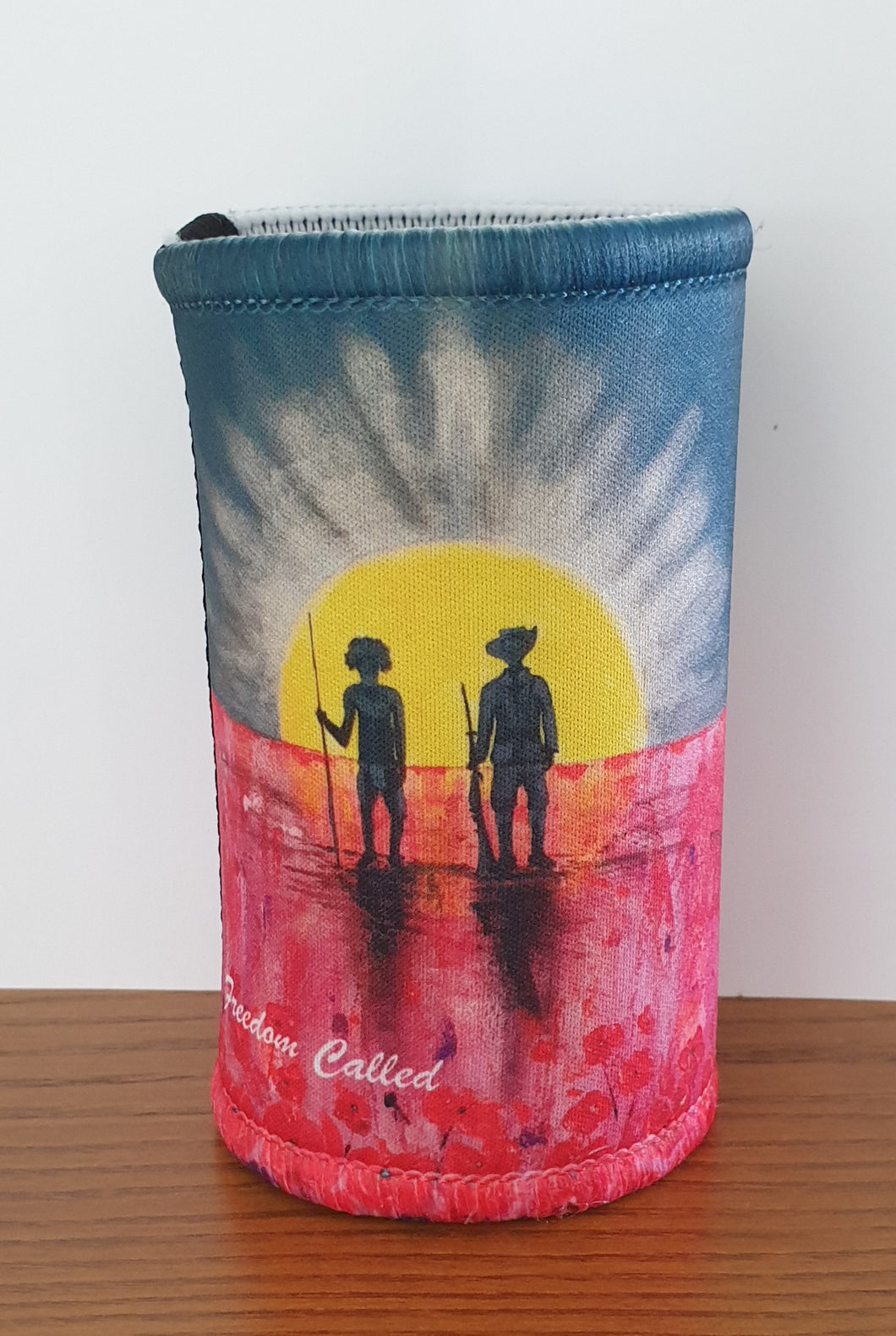 Original painting of a rising sun which is an abstract version of the Aboriginal flag with the silhouette of an Aboriginal holding a spear and a soldier holding a gun surrounded by red poppies on a double stitched, excellent quality stubby holder / cooler