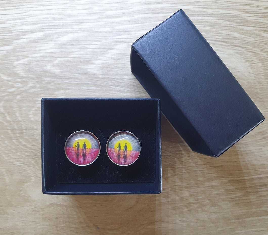 Original painting of a rising sun which is an abstract version of the Aboriginal flag with the silhouette of an Aboriginal holding a spear and a soldier holding a gun surrounded by red poppies on 16mm surgical steel stud earrings