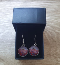 Load image into Gallery viewer, 16mm Earrings - Sunrise (ANZAC Crest), silhouette of soldier with horse drinking from a hat, a field of red &amp; purple poppies
