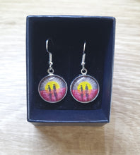 Load image into Gallery viewer, Original painting of a rising sun which is an abstract version of the Aboriginal flag with the silhouette of an Aboriginal holding a spear and a soldier holding a gun surrounded by red poppies on 16mm surgical steel fishhook earrings
