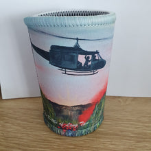 Load image into Gallery viewer, Original painting of a huey helicopter hovering over red smoke and poppies in Vietnam on double stitched excellent quality stubby holder / cooler
