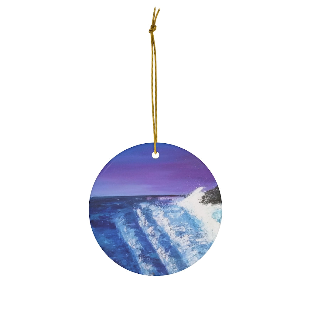 Original painting of crashing waves at sunset on a round ceramic ornament with hanging string