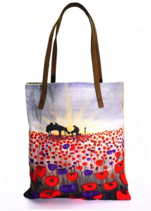 original artwork of a sunrise (in the form of the ANZAC Crest) with a silhouette of a soldier kneeling next to his horse drinking from his hat in a field of red and purple poppies on a large tote bag with leather straps and internal pockets