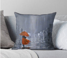 Load image into Gallery viewer, Original painting of a grey tone abstract rainy cityscape with a lady wearing a red coat under a red umbrella and water reflections on 40 x 40cm cushion covers
