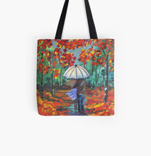 Load image into Gallery viewer, original painting of a couple under an umbrella surrounded by autumn / fall coloured leaves on a 41 x 41cm tote bag
