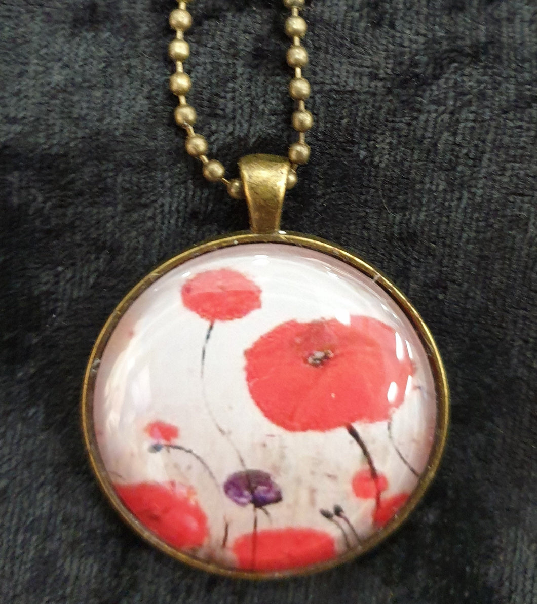 Original painting of red poppies with an abstract background on a bronze coloured 30mm pendant with a 60cm ball chain
