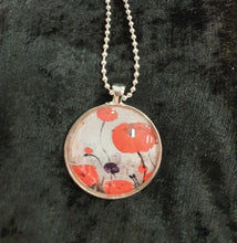 Load image into Gallery viewer, Original painting of red poppies with an abstract background on a silver coloured 30mm pendant with a 60cm ball chain
