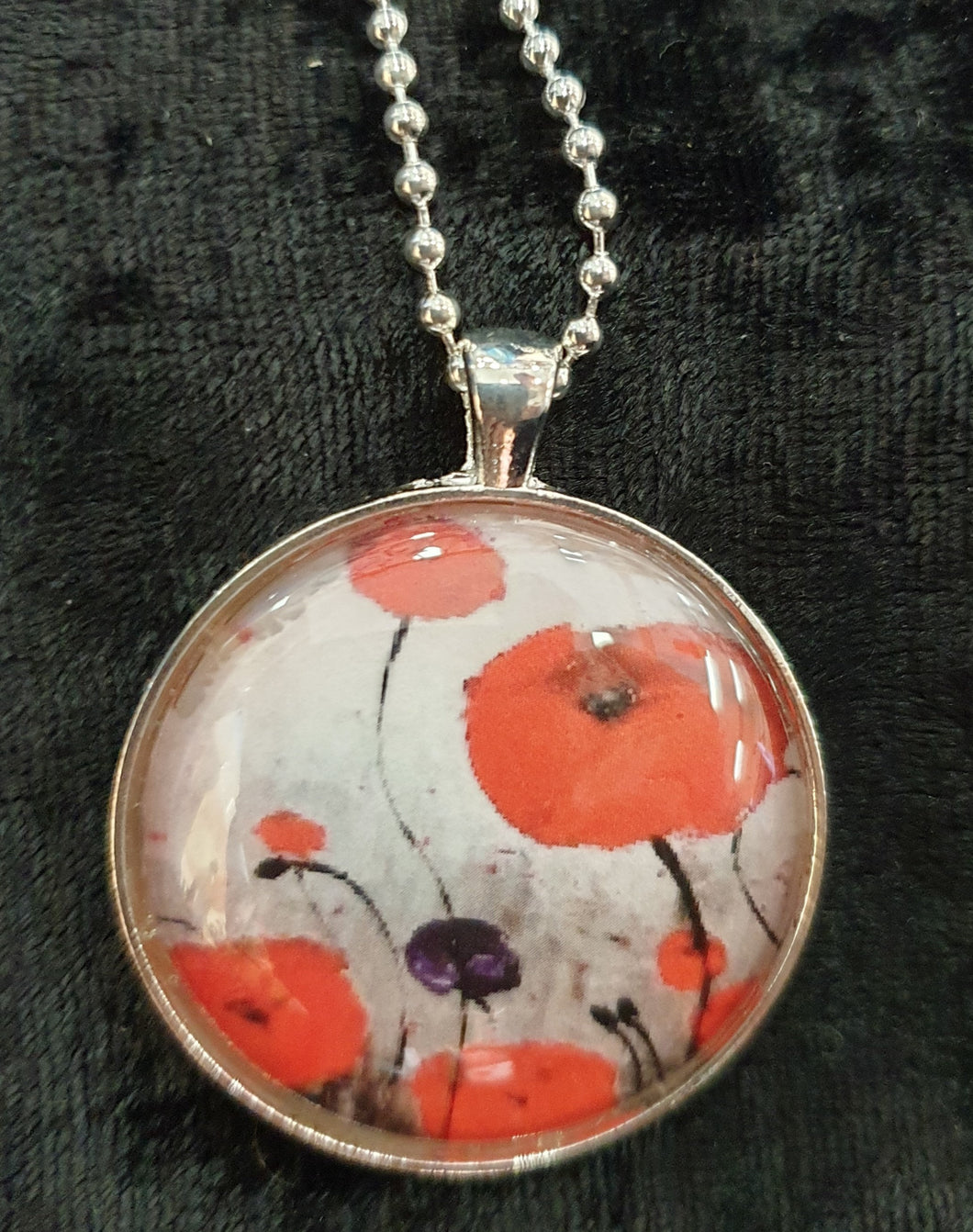 Original painting of red poppies with an abstract background on a silver coloured 38mm pendant with a 60cm ball chain