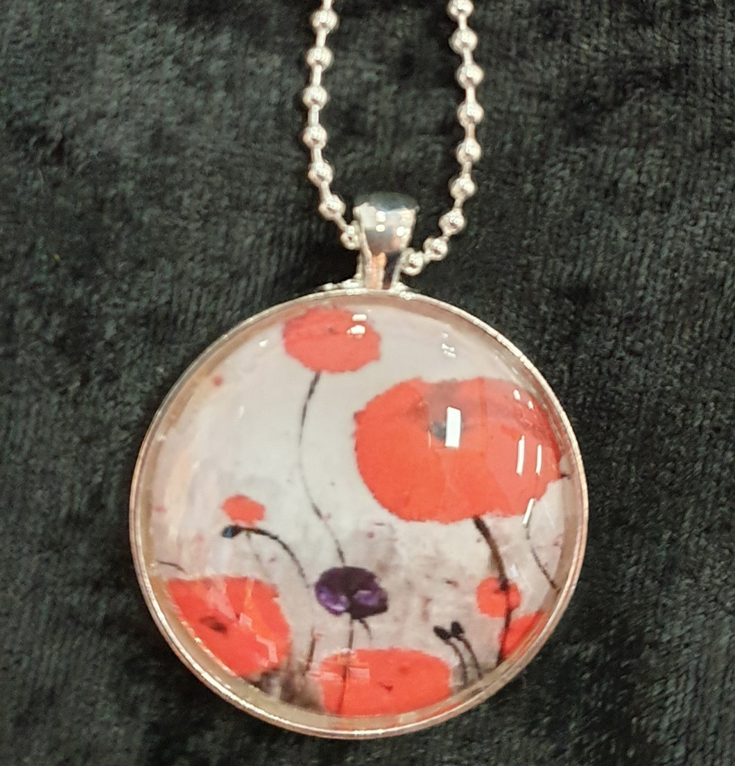 Original painting of red poppies with an abstract background on a silver coloured 30mm pendant with a 60cm ball chain
