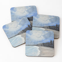 Load image into Gallery viewer, Original painting of a pine tree lined beach with sunrays poking through the clouds on cork backed coasters
